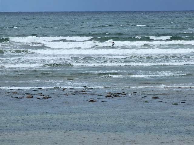 Surfer finishing out a wave in front of the shop